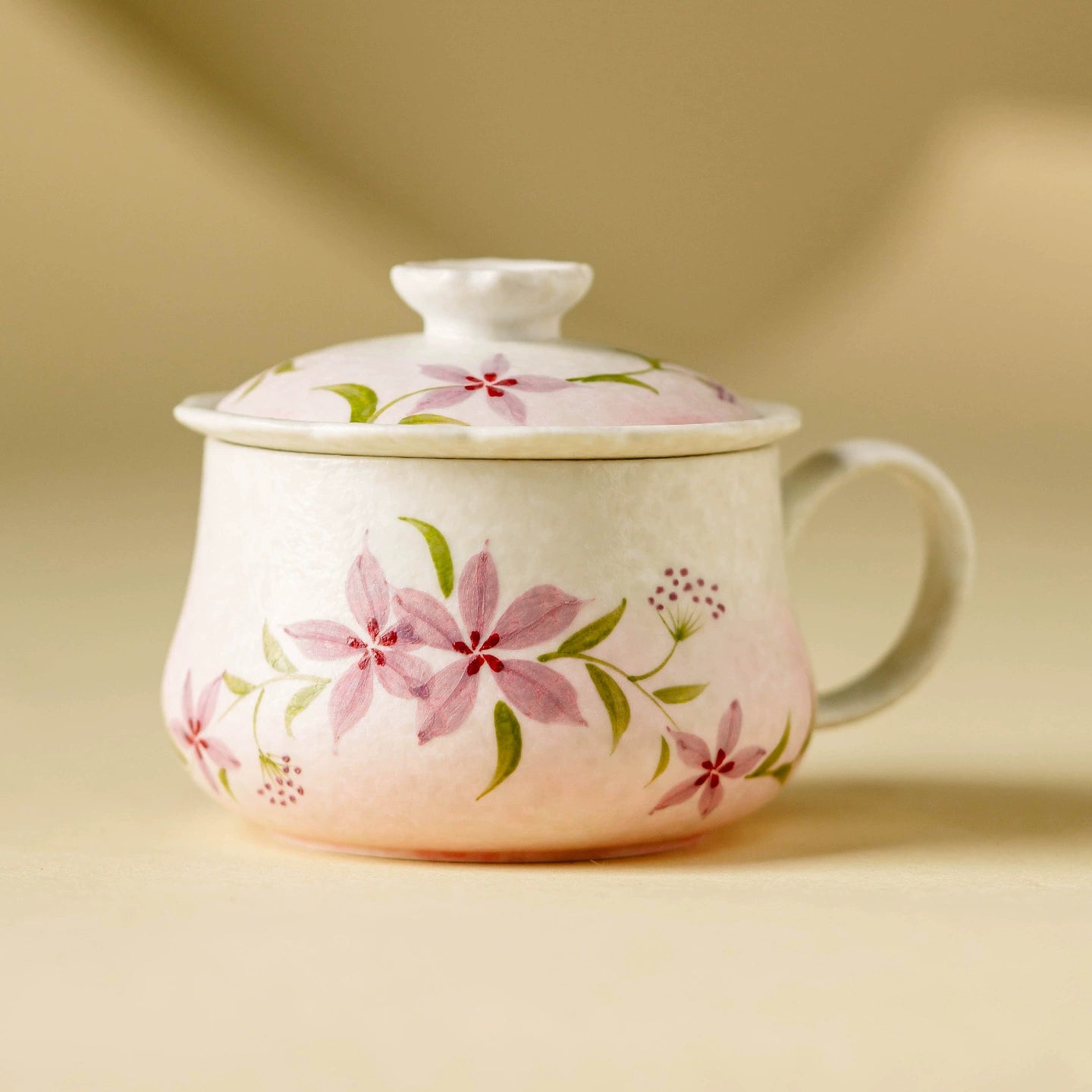 Hand-painted floral ceramic tea cup with lid