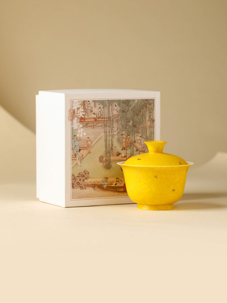 Hand-painted floral detail on a textured yellow porcelain surface of an aroma-concentrating gaiwan.