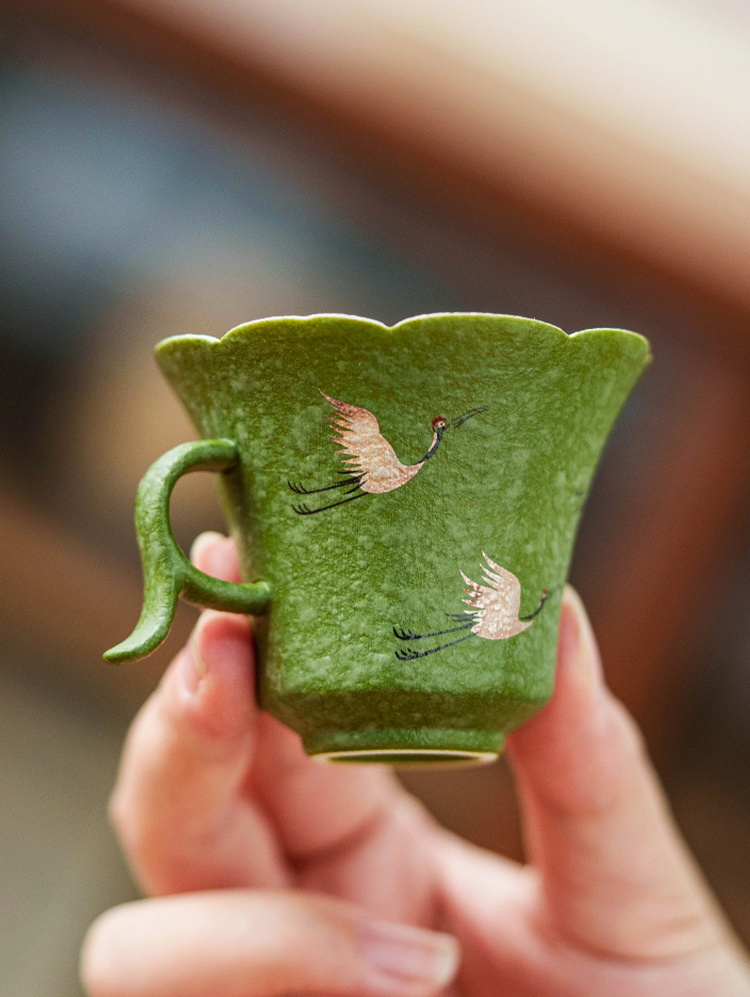 Hand-painted porcelain tea cup with flared mouth and minimalist oriental elegance
