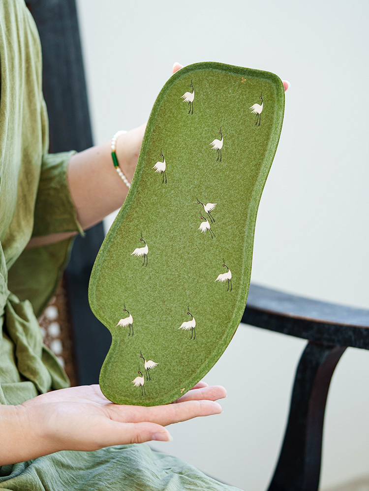 Hand-painted porcelain tea plate featuring flying crane pattern