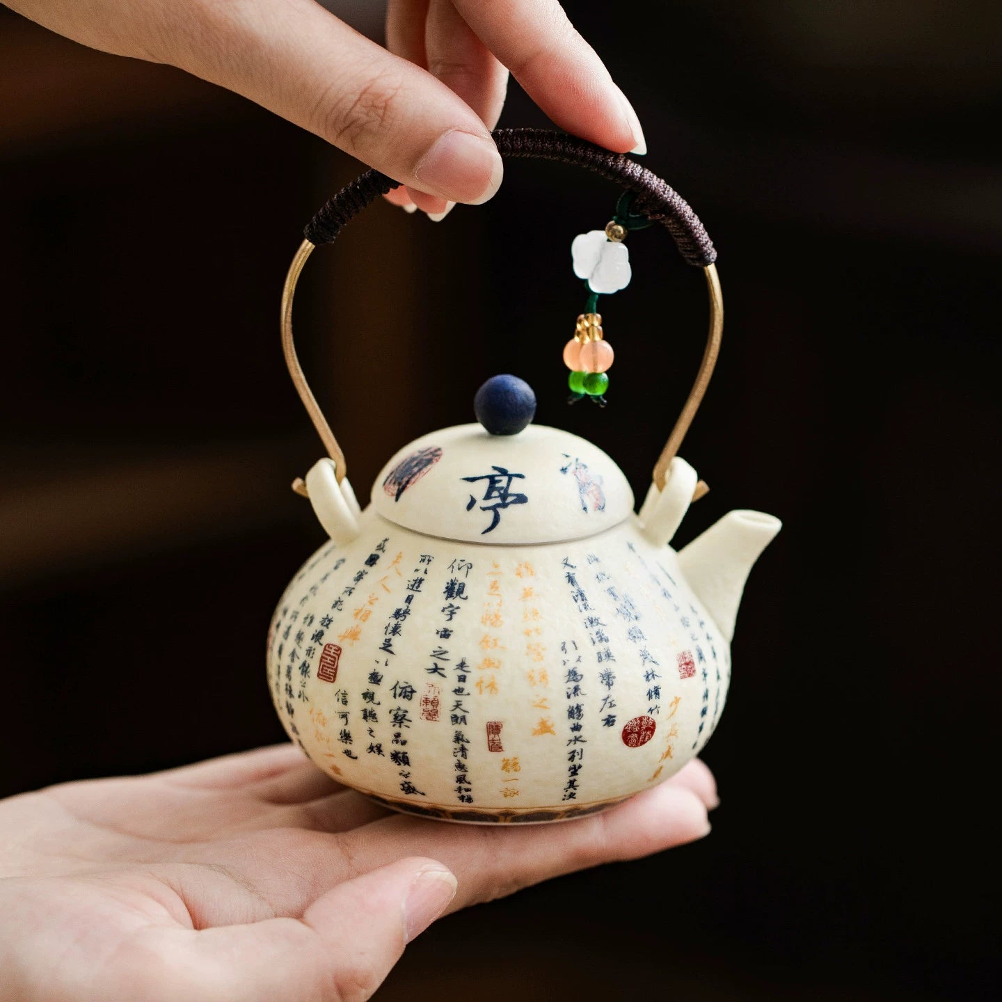 Hand-painted porcelain teapot with brass handle