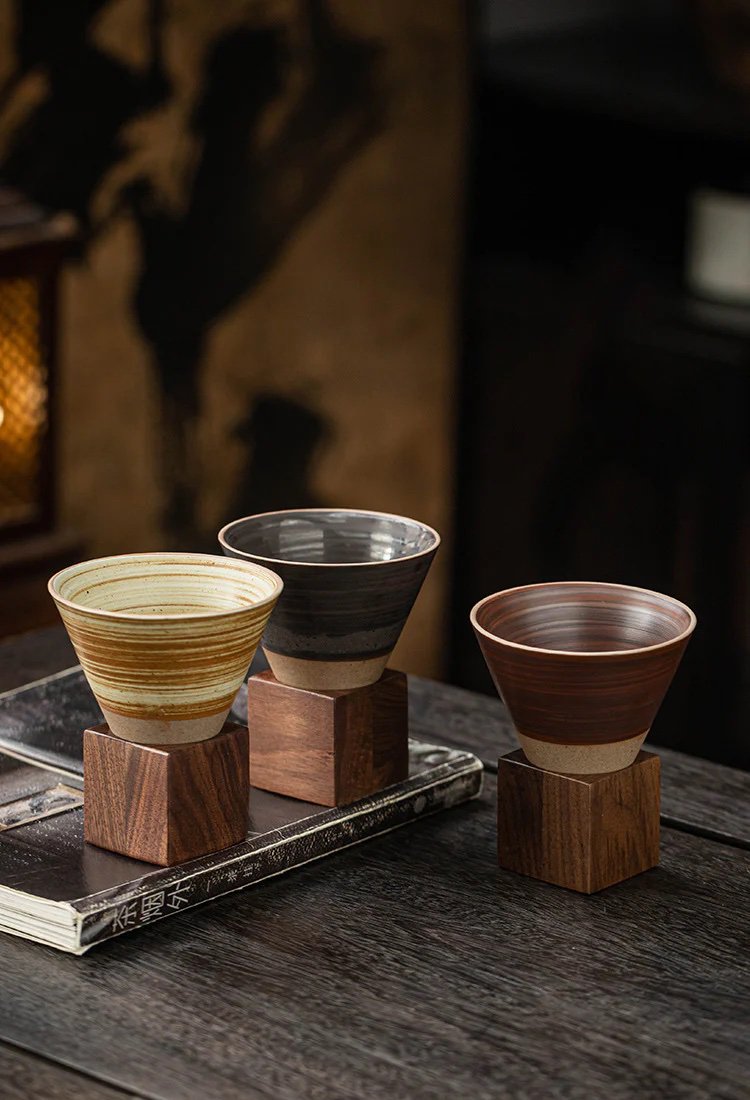 Coffee pouring into handmade cone ceramic mug
