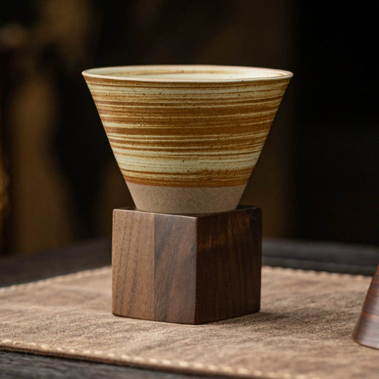 Handcrafted ceramic coffee cup with square wooden base

