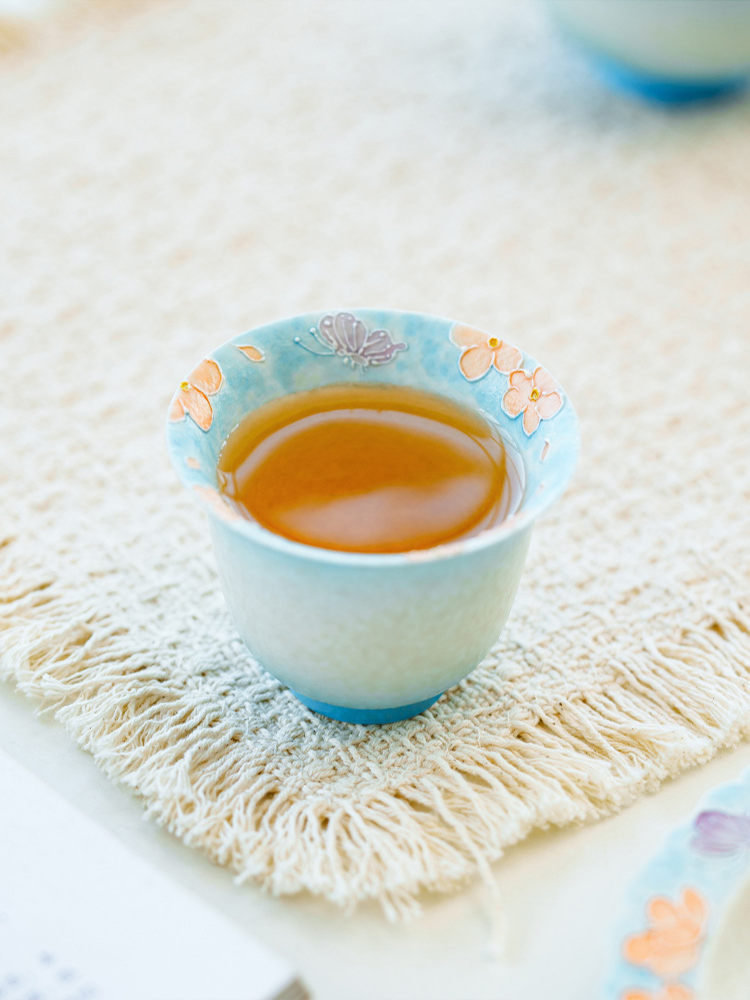Handcrafted ceramic tea cup with artistic floral design