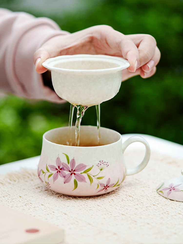 Handcrafted ceramic tea cup with botanical design