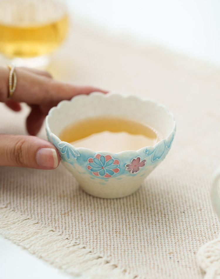Handcrafted ceramic tea cup with flowers