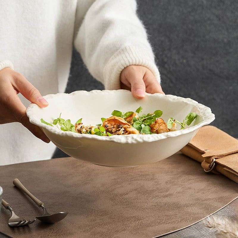 Handcrafted porcelain bowl with organic irregular edge.