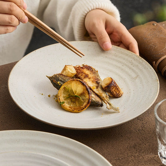 Handcrafted stoneware dinner plate with spiral texture


