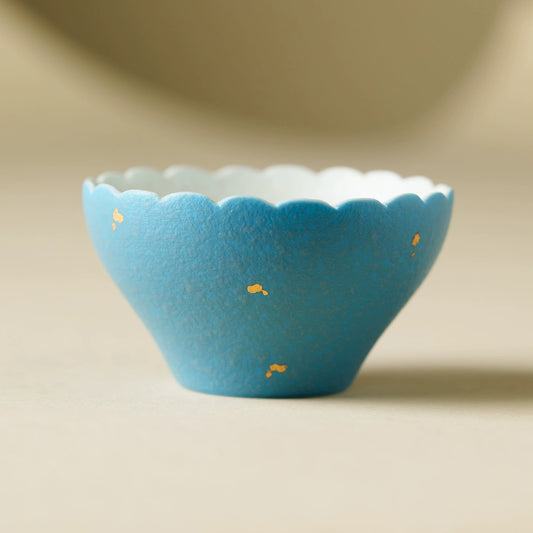 Handmade blue ceramic teacup with scalloped rim