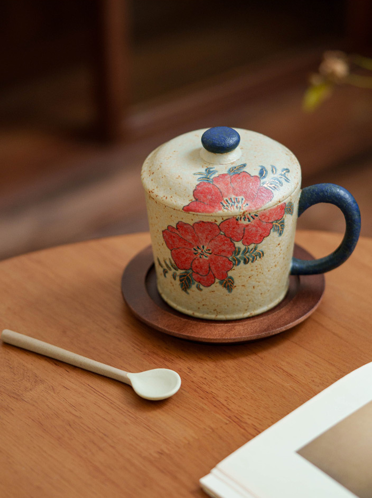 Handmade ceramic coffee mug with Japanese-inspired floral art