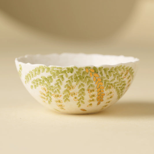 Handmade ceramic teacup with green leaf motif