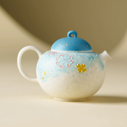 Handmade ceramic teapot with blue lid
