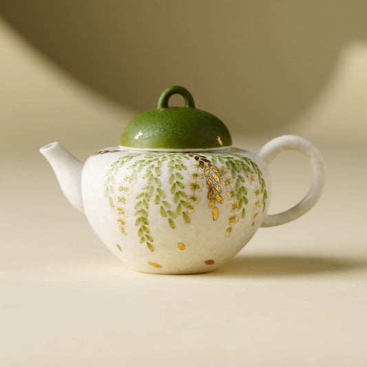 Handmade ceramic teapot with green leaf design