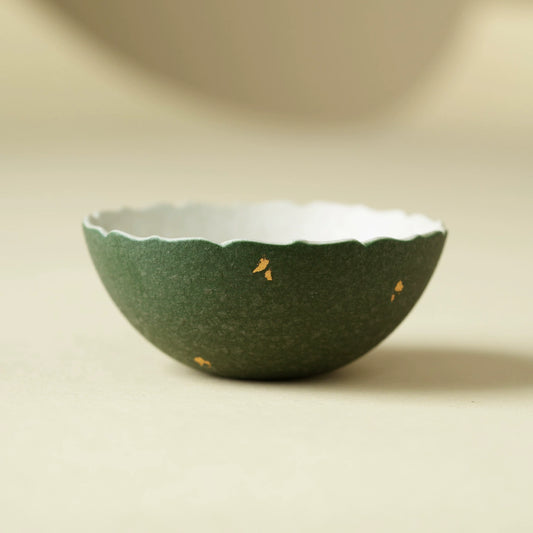 Handmade green ceramic teacup with scalloped rim