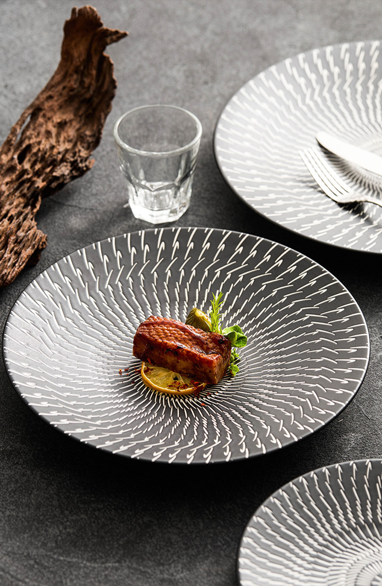 Handmade porcelain dinnerware featuring minimalist artistic detail