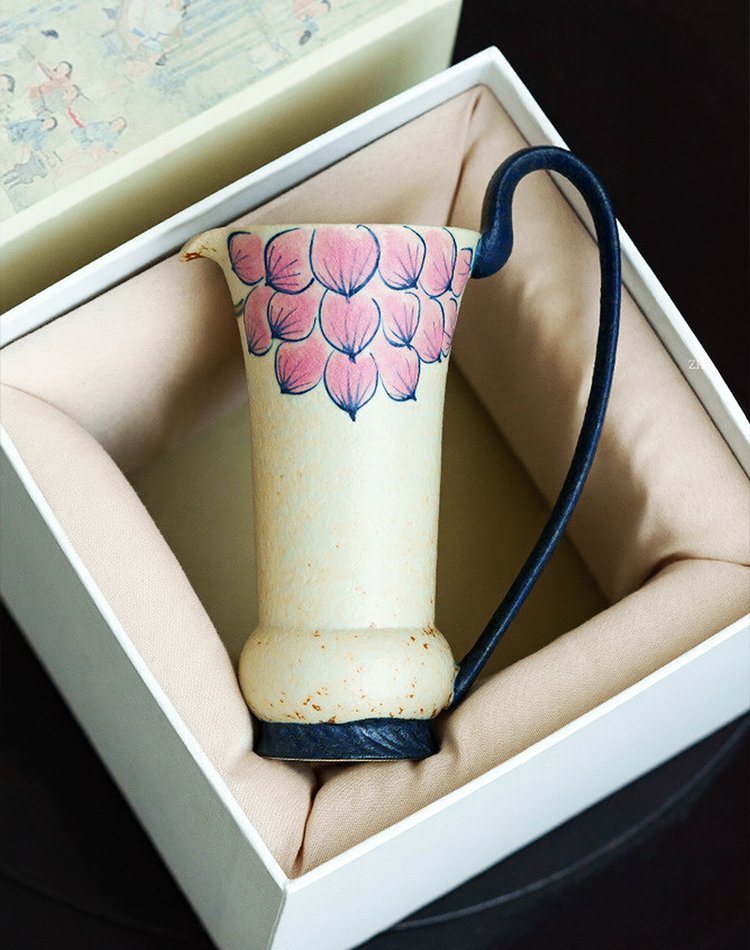 Handmade pottery jug with long dark handle