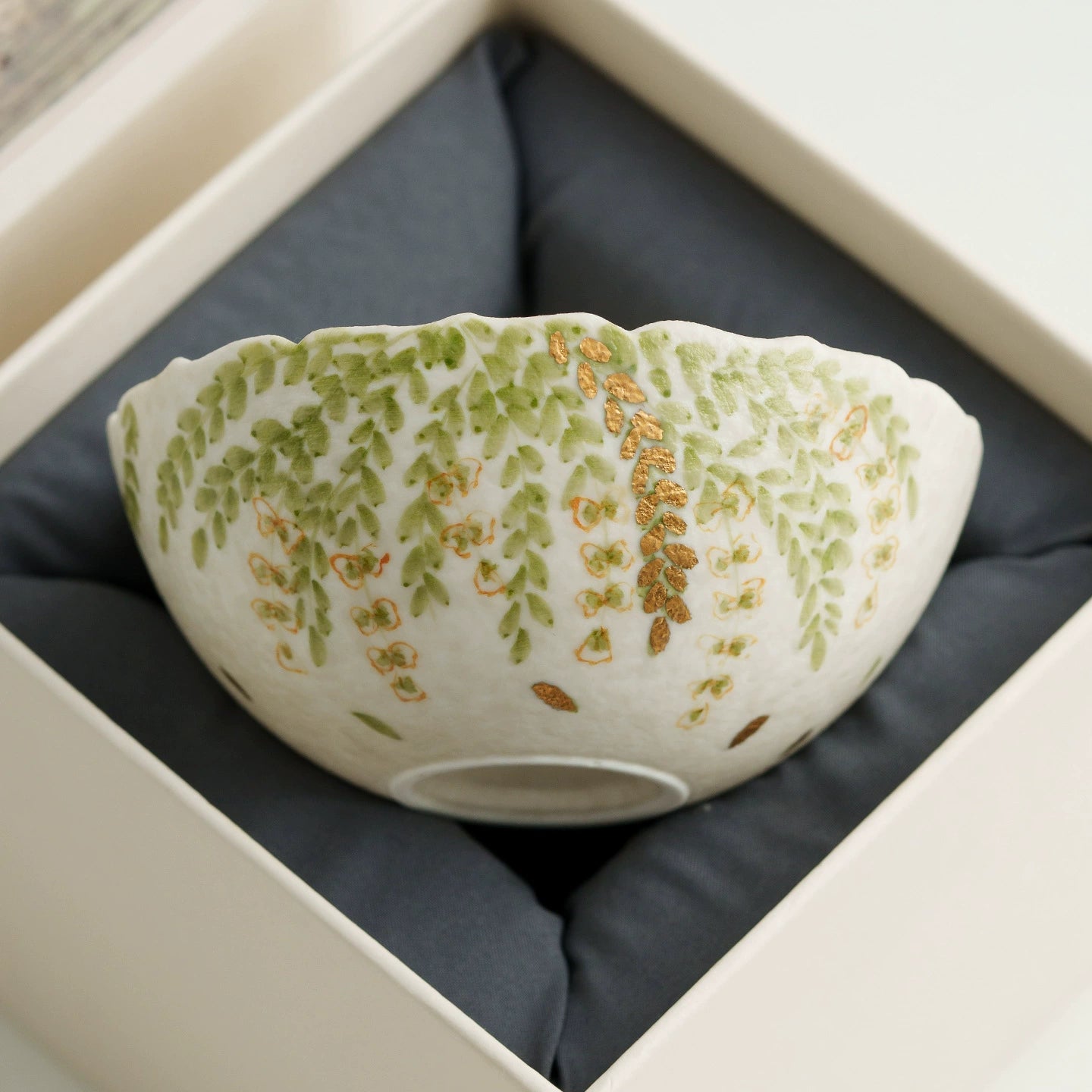 Handmade scalloped rim ceramic teacup with foliage pattern