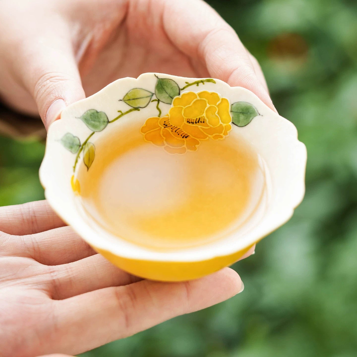 Heritage Series tea cup featuring a vibrant yellow exterior and textured white floral interior.