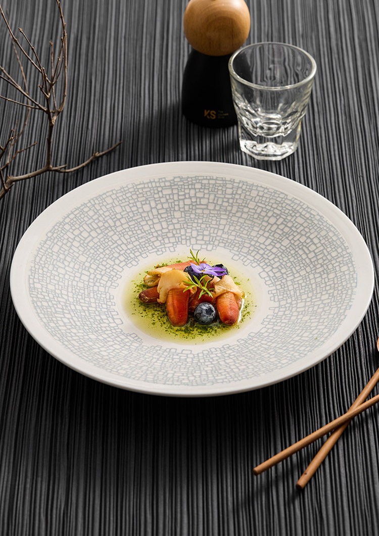 High-contrast culinary presentation on a mosaic-inspired porcelain canvas.