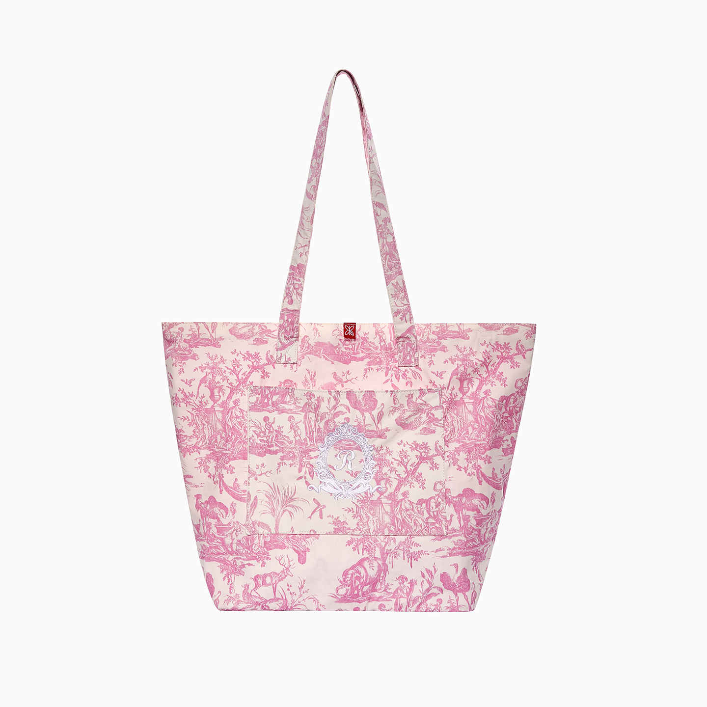 High-quality pink French Toile de Jouy tote bag featuring a white embroidered royal emblem and front pocket.