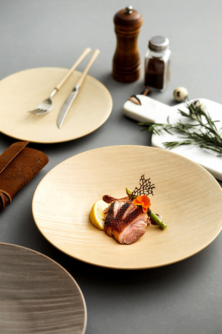 Dish with roasted meat and garnishes on a wooden plate with cutlery and spices in the background.