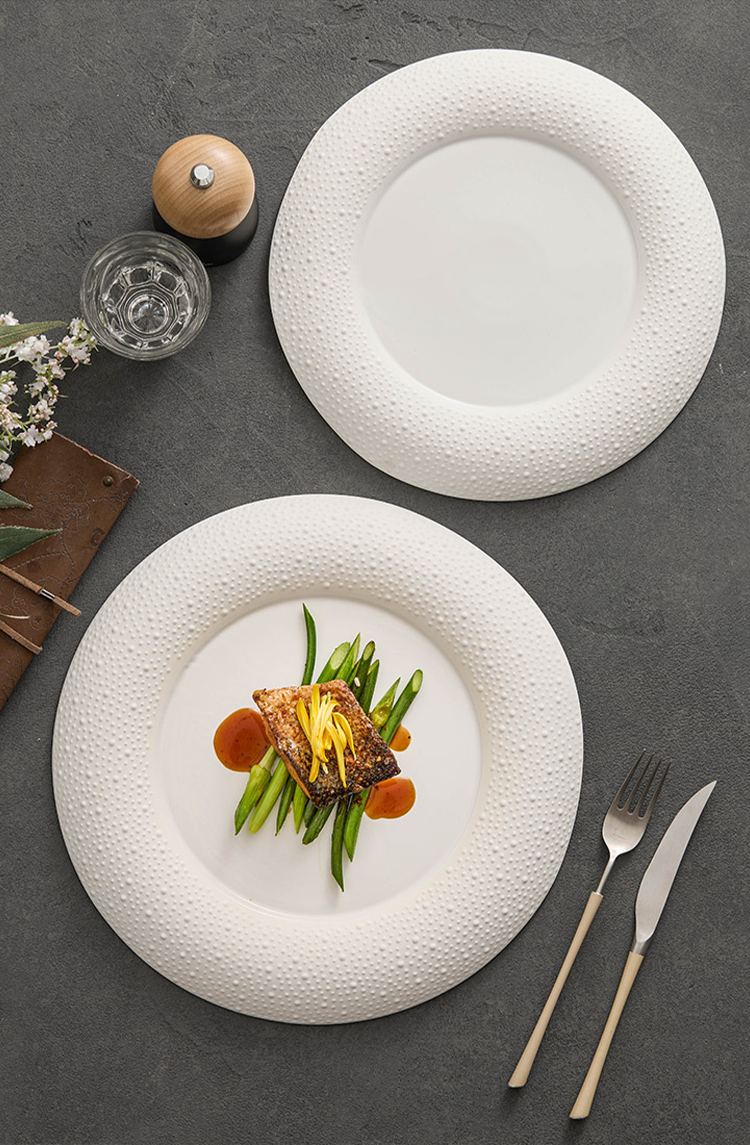 High-temperature porcelain plate featuring subtle pebble pattern along edges.