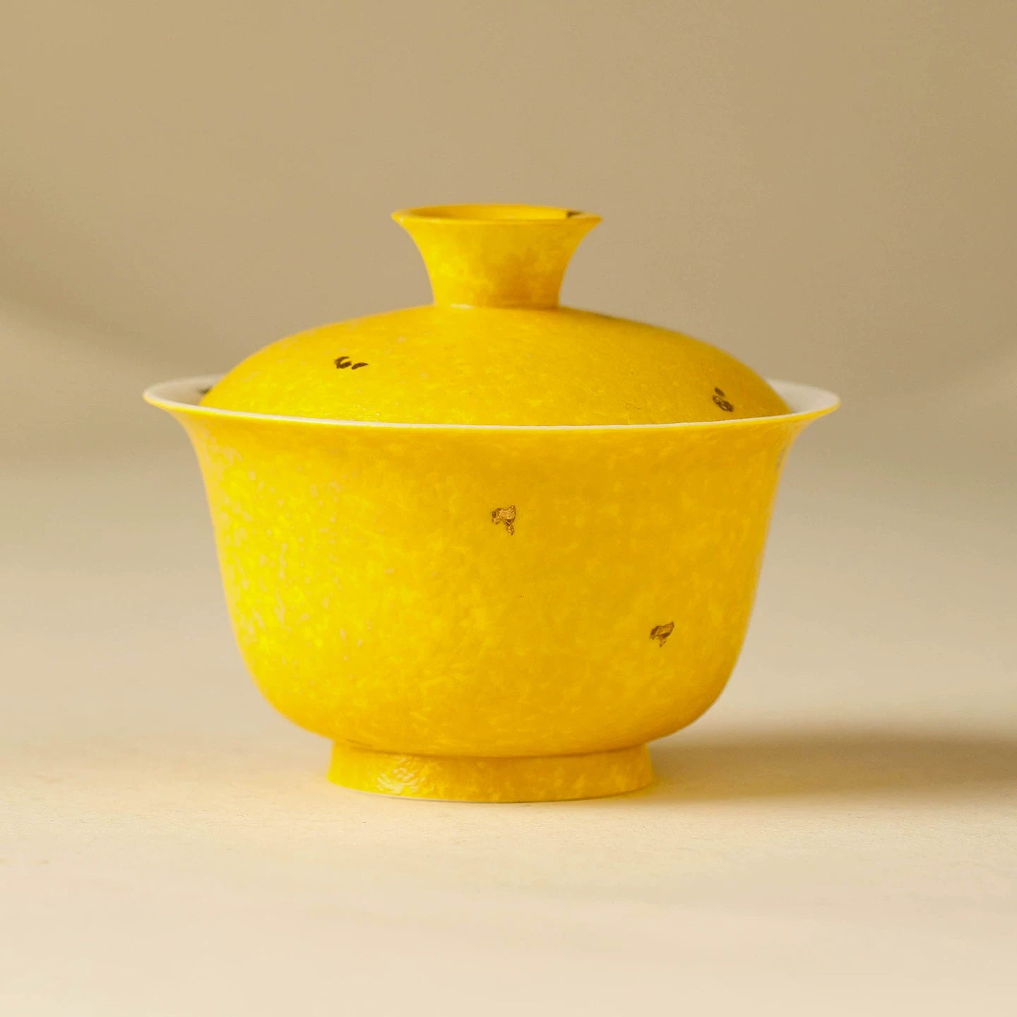 Imperial yellow aroma-concentrating gaiwan featuring a unique stone-like textured glaze and hand-painted floral motifs.