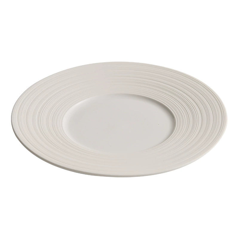 White ceramic plate with concentric circle design on a white background