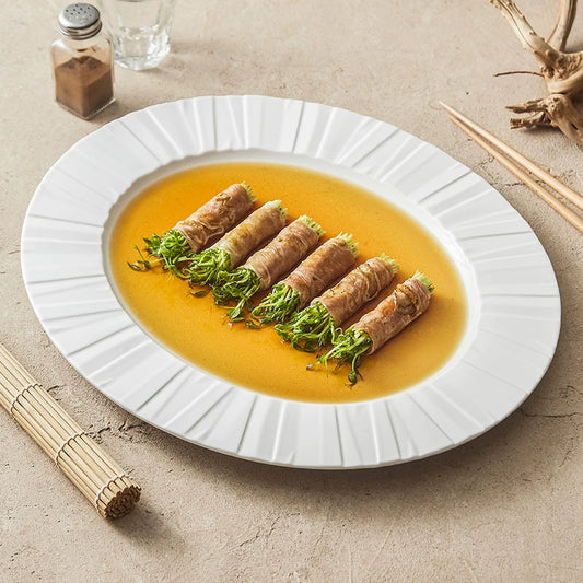 Large oval ceramic serving platter with radiating rim texture