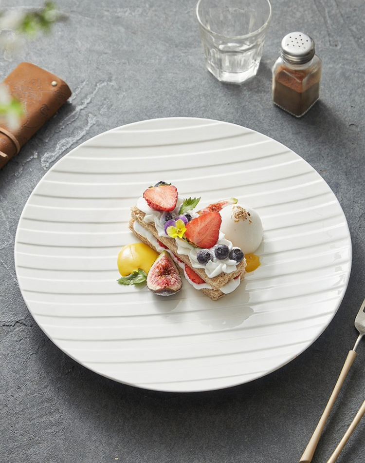 Large white ceramic plate with modern stripe embossing