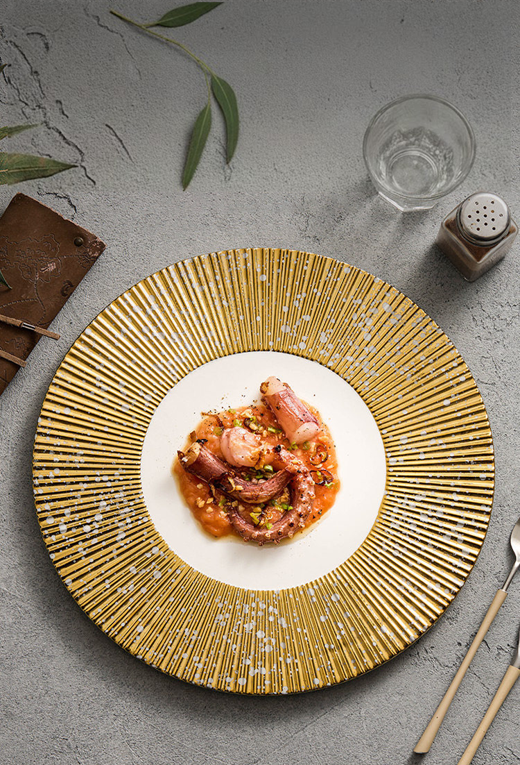 Luxury gold-textured ceramic dinnerware with hand-finished blue flecks.