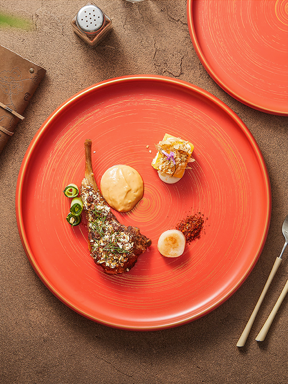 Matte glazed ceramic plate with sculpted rim and metallic accent