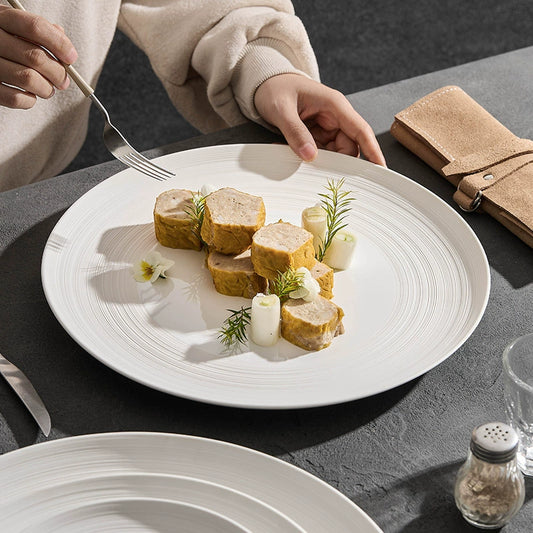 Minimalist ceramic dinner plate with concentric line pattern

