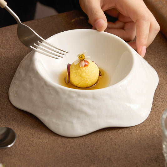 Minimalist high-fired porcelain bowl in moon white with organic petal edges