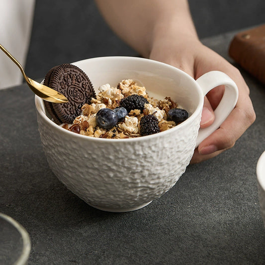 Minimalist porcelain cup with natural stone texture and curved handle
