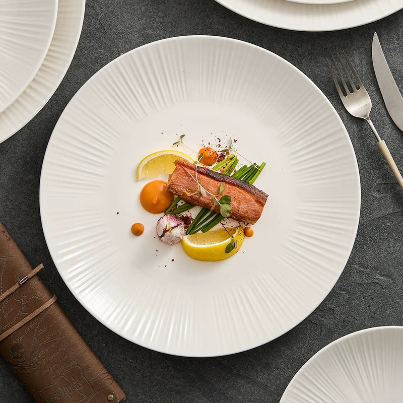 Minimalist sunray-textured ceramic plate in matte ivory finish by GOSEUNG.