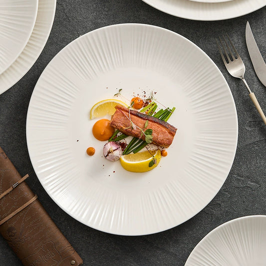 Minimalist sunray-textured ceramic plate in matte ivory finish by GOSEUNG.