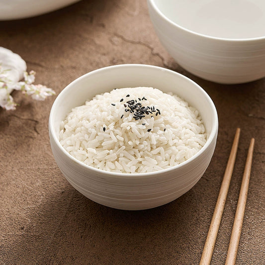 Minimalist white ceramic rice bowl with brushed texture

