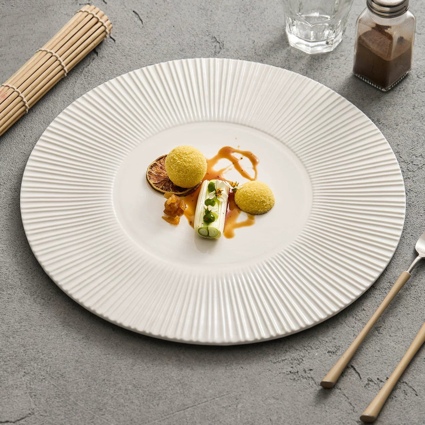 Minimalist white radial gear charger plate with 12-inch diameter.