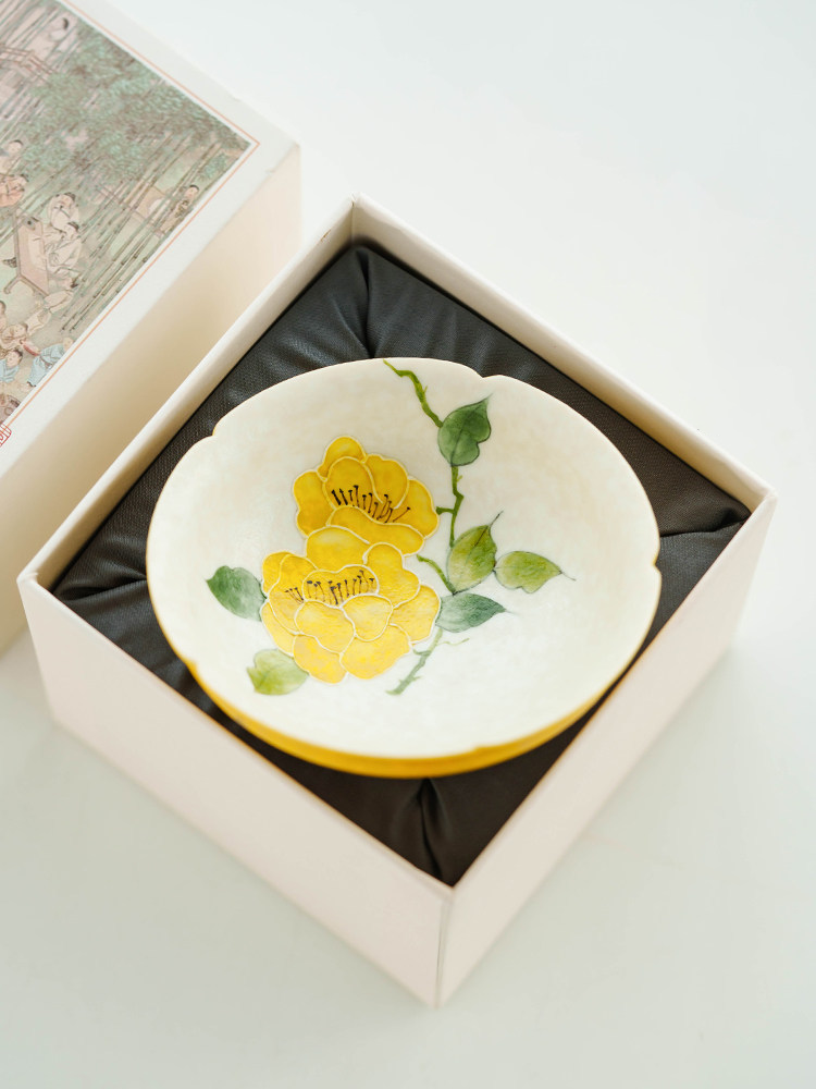 Minimalist yellow and white porcelain tea cup for artisanal tea drinking.