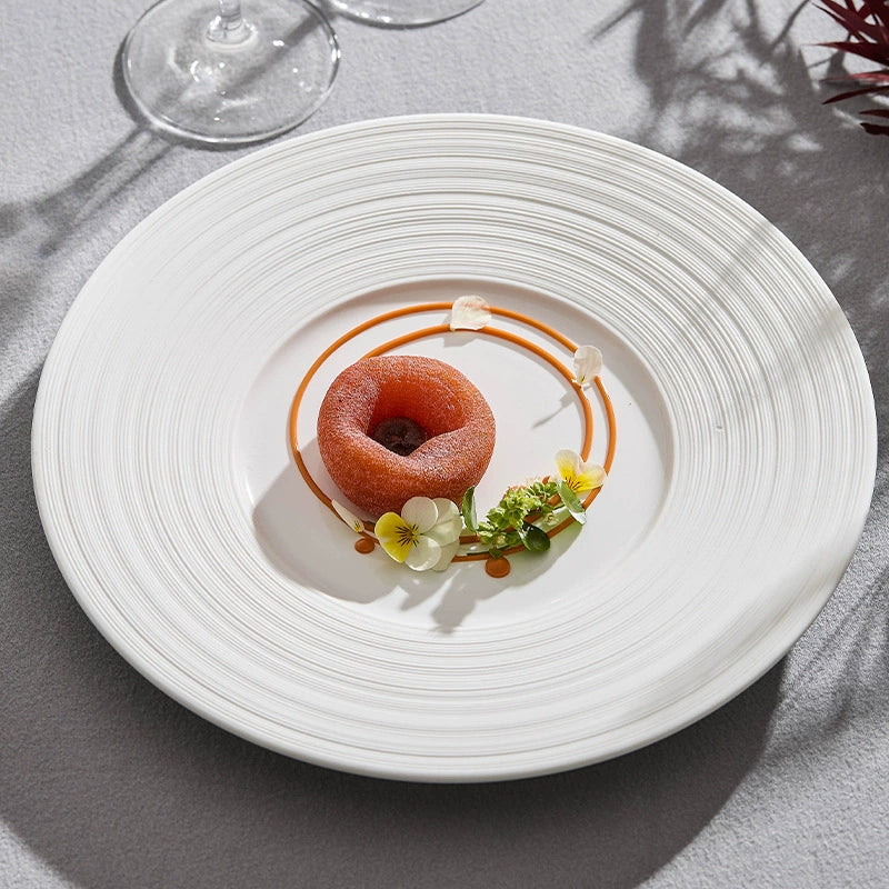 Delicate dessert presentation on a white plate with a gray background