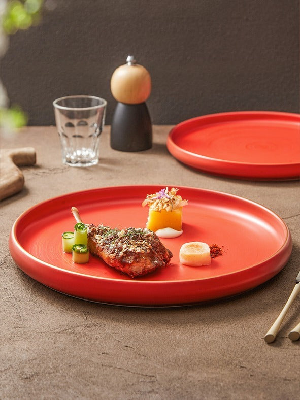 Modern ceramic serving plate with raised edge and gold detailing