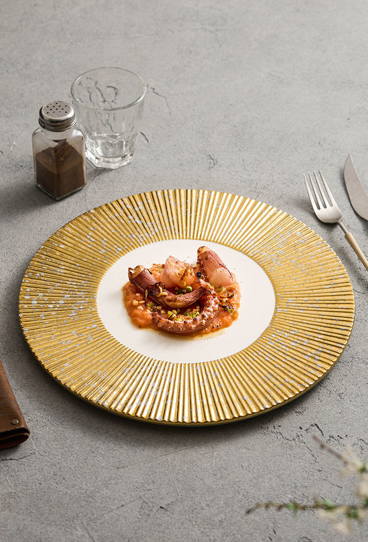 Modern gold and white service plate with 16.5cm inner well diameter.