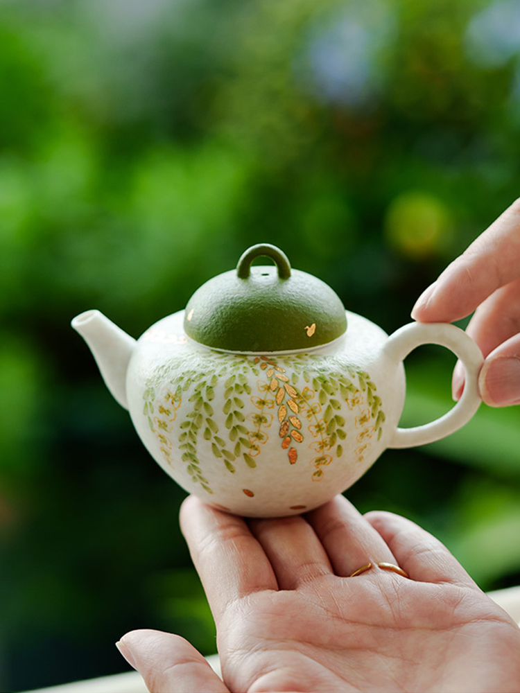 Modern handmade ceramic teapot with foliage design