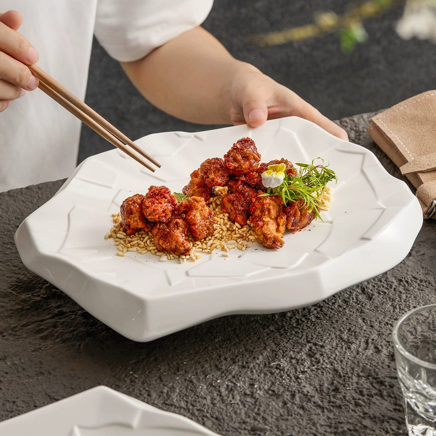 Modern irregular ceramic plate with white crack pattern.