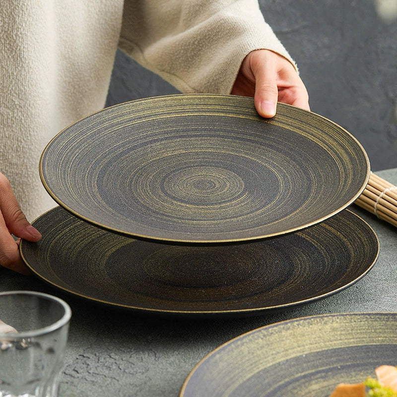 Modern matte black plate with hand-painted gold brushwork