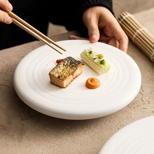 Modern minimalist 8-inch round well plate for appetizers and starters.