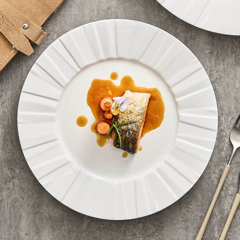 Modern origami-inspired porcelain dinner plate with pleated rim