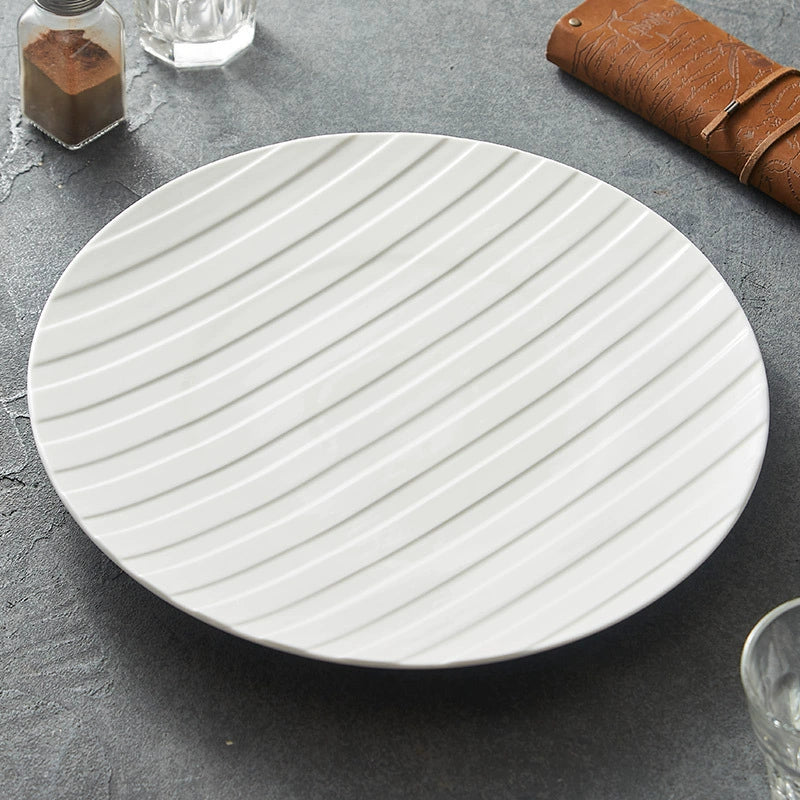 Modern white ceramic plate with striped surface design