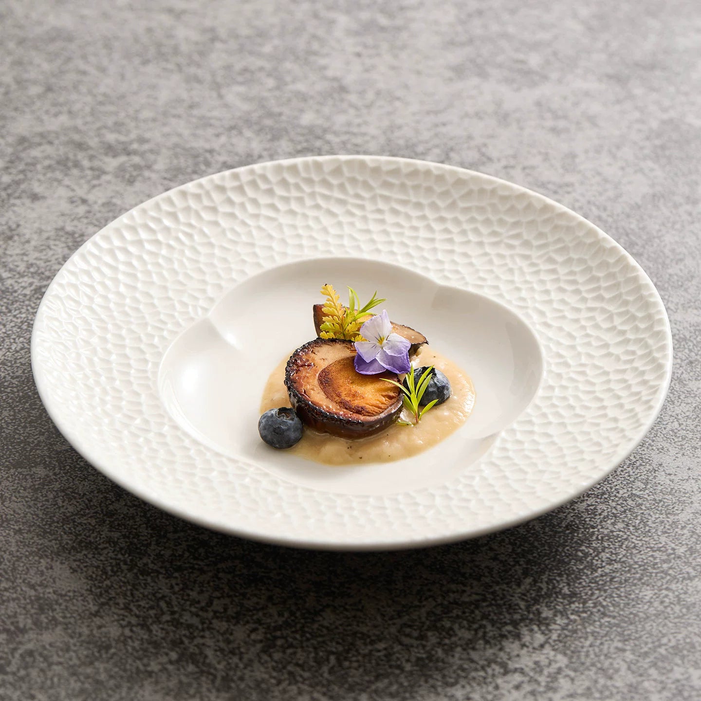 Modern white matte porcelain plate with a floral-shaped central well.